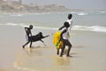 African children on the beach with goat