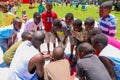 African children doing a sports team huddle on basketball court