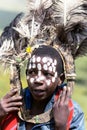 African children with ostrich feather headdress and painted markings of face