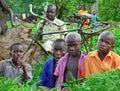 African children sitting in vegetable garden & old bike Royalty Free Stock Photo
