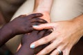 African children is touching a tourist`s hands. Different skin colors.