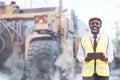 African civil engineering standing against the truck with holding tablet in hands. The technician working with use tablet for