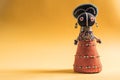 African cloth doll on yellow background