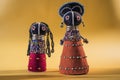 African cloth dolls on yellow background