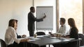 African coach makes presentation for staff sales results on flipchart Royalty Free Stock Photo