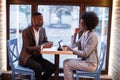 African colleagues discussing working issues at cafe Royalty Free Stock Photo