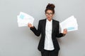 African confused business woman with diagramas documents