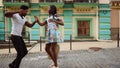 African couple dancing jive in city. Sexy afro dancers making footwork on street