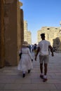 African couple on an excursion in Karnak Temple. Tourists among the ancient ruins. Beautiful Egyptian landmark