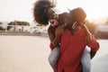 African couple having fun outdoors wearing face masks - Focus on man face Royalty Free Stock Photo