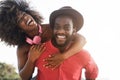 African couple having fun together outdoors - Focus on man face Royalty Free Stock Photo