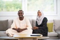 African couple at home reading quaran