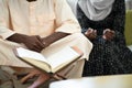 African couple at home reading quaran