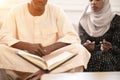 African couple at home reading quaran