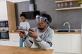 African couple play video games wearing virtual reality glasses at home