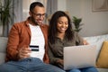 African Couple Shopping Online Via Laptop And Credit Card Indoor Royalty Free Stock Photo