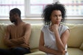 African couple sitting apart thinking about relations problems Royalty Free Stock Photo