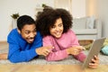 African Couple Using Tablet Engaging in Digital Fun At Home Royalty Free Stock Photo