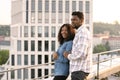 African couple woman and man hugging on rooftop of modern building. Royalty Free Stock Photo