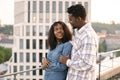 African couple woman and man hugging on rooftop of modern building. Royalty Free Stock Photo