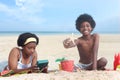 African curly hair boy and girl sibling on beach. Happy smiling two kid friend playing together on sand beach. Joyful children Royalty Free Stock Photo