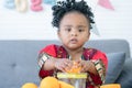 African cute kid girl squeezing fresh oranges at home. Adorable child happy to making freshly squeezed orange juice on manual Royalty Free Stock Photo