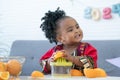 African cute kid girl squeezing fresh oranges at home. Adorable child smiling while making freshly squeezed orange juice on manual Royalty Free Stock Photo