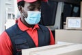 African delivery man wearing face protective mask during coronavirus outbreak - Focus on face Royalty Free Stock Photo
