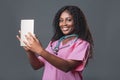 An African doctor consults a patient, makes a video call from a webcam on the tablet screen. Telemedicine videoconference remote Royalty Free Stock Photo