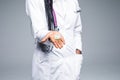 African doctor holding pills close up isolated on gray background Royalty Free Stock Photo