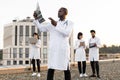 African doctor holding x-ray scan of patient during break outdoors hospital. Royalty Free Stock Photo