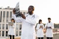 African doctor holding x-ray scan of patient during break outdoors hospital. Royalty Free Stock Photo