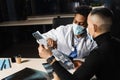 African doctor show x-ray asian patient. Pneumonia and pleurisy. Black surgeon analyzing x ray and diagnosis patient in