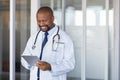 African doctor using digital tablet at hospital