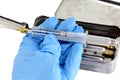 doctor with a vintage glass syringe and steel container to sterilize medical equipment in a hospital Royalty Free Stock Photo