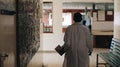 African doctor in white medical gown walking through the hospital lobby in village in Africa. Royalty Free Stock Photo
