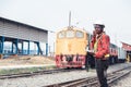 African engineer control a the train on railway with talking by radio communication or walkie talkie