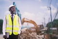 African engineer man or architect checking construction with white safety helmet in construction site. Standing at highway Royalty Free Stock Photo
