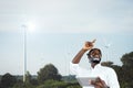 An African engineer stands to inspect a wind turbine system with using a tablet.Concept of renewable energy technology and the Royalty Free Stock Photo