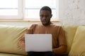 African ethnicity guy gawp at laptop screen feels shocked Royalty Free Stock Photo