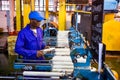 African factory worker on a copwinder weft assembly line loom