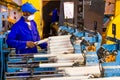 African factory worker on a copwinder weft assembly line loom