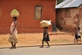 African family carrying banana basket on the head