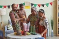 African family of four celebrating Kwanzaa at home
