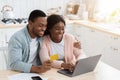 African Family Paying Utility Bills At Home With Laptop And Credit Card Royalty Free Stock Photo