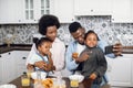 African family using mobile during breakfast on kitchen Royalty Free Stock Photo