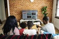 African family watching television together