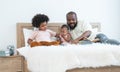 African family, 5 years boy, cute 11 months toddler baby girl and father have fun playing car model toy and reading book together Royalty Free Stock Photo