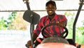 African farmer driving tractor in farm during harvest in countryside. Agriculture or cultivation concept Royalty Free Stock Photo