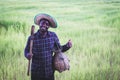 African farmer is happily working and cultivating on his farm with holding agricultural tools.Agriculture or cultivation concept